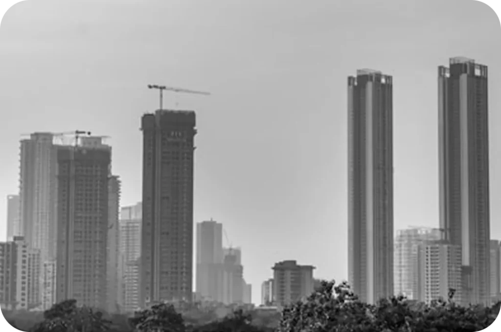 High-rise buildings under construction dominate the skyline, with cranes visible atop several towers.